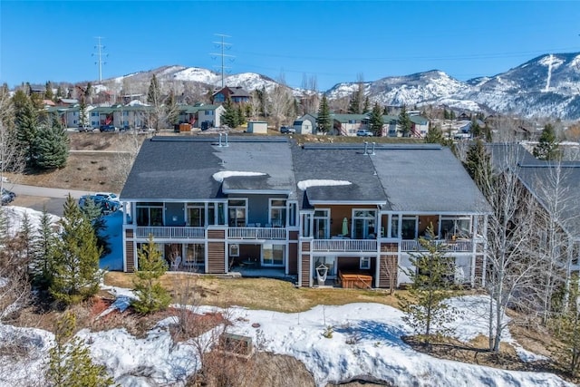 471 Mountain Vista Cir Unit 1, Steamboat Springs, CO 80487 - view of front of house with stairs, a deck with mountain view, a residential view, and roof with shingles