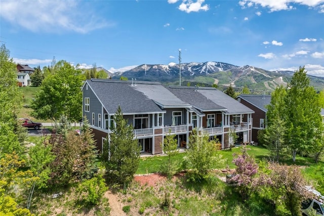 471 Mountain Vista Cir Unit 1, Steamboat Springs, CO 80487 - rear view of property with stairway, roof with shingles, and a deck with mountain view