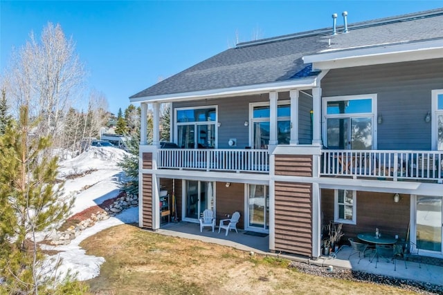 471 Mountain Vista Cir Unit 1, Steamboat Springs, CO 80487 - back of house featuring a balcony, a patio area, and a shingled roof