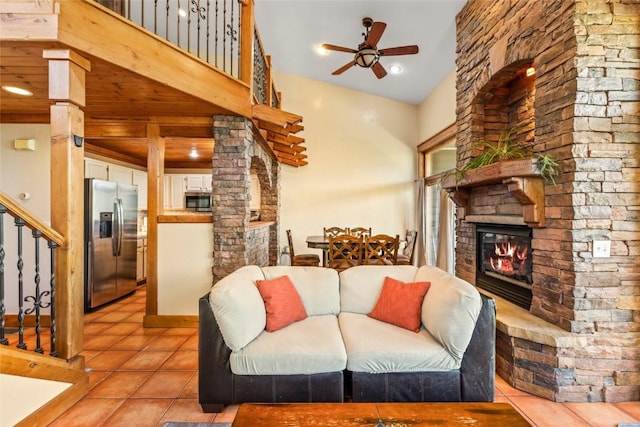 471 Mountain Vista Cir Unit 1, Steamboat Springs, CO 80487 - living room featuring a fireplace, ceiling fan, light tile patterned floors, and stairs