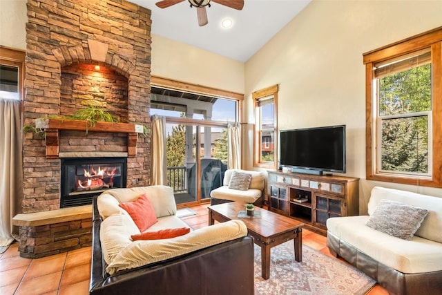 471 Mountain Vista Cir Unit 1, Steamboat Springs, CO 80487 - tiled living area featuring a ceiling fan, a stone fireplace, and vaulted ceiling