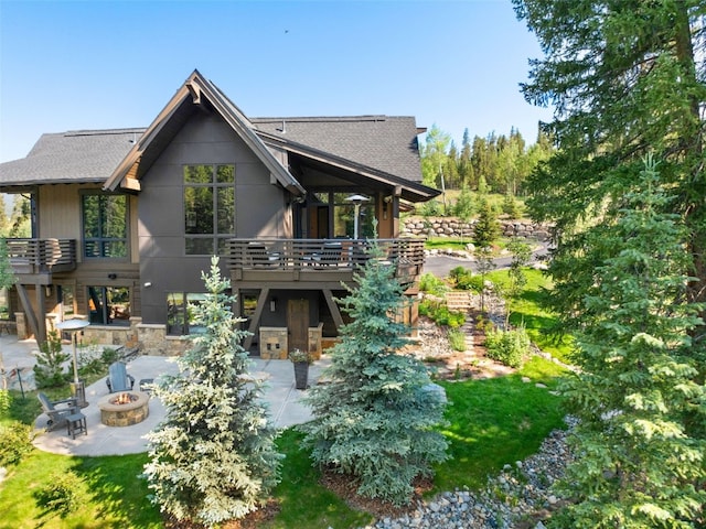 315 River Park Dr, Breckenridge, CO 80424 - back of property featuring a fire pit, a patio area, a shingled roof, a deck, and stone siding
