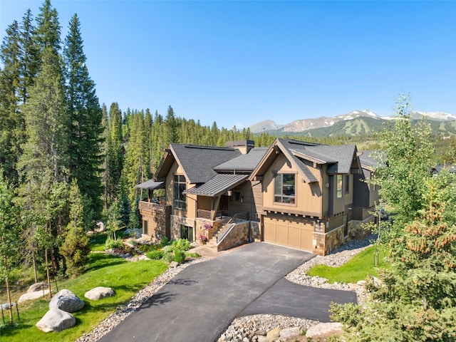 315 River Park Dr, Breckenridge, CO 80424 - chalet / cabin with stone siding, a standing seam roof, a garage, a mountain view, and a metal roof