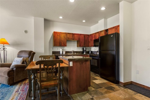 505 S Main St Unit 2305, Breckenridge, CO 80424 - kitchen featuring black appliances, a sink, open floor plan, dark countertops, and baseboards