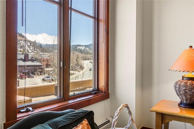 505 S Main St Unit 2305, Breckenridge, CO 80424 - detailed view of a textured wall, baseboards, a baseboard radiator, and a mountain backdrop
