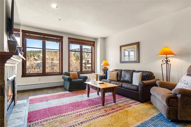 505 S Main St Unit 2305, Breckenridge, CO 80424 - living area featuring a baseboard radiator, a textured ceiling, a fireplace, wood finished floors, and recessed lighting