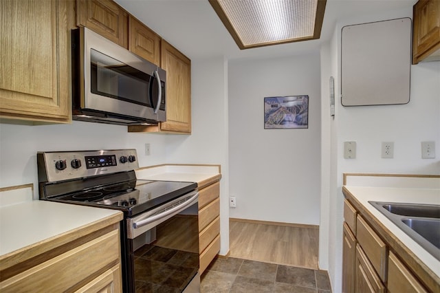 400 Bayview Dr Unit D, Frisco, CO 80443 - kitchen with stainless steel appliances, light countertops, dark wood-style floors, and baseboards