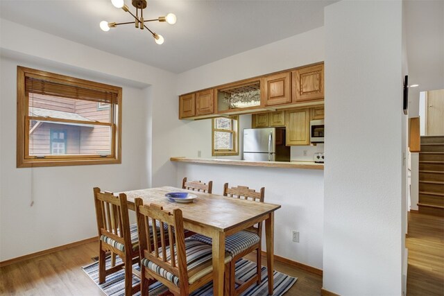 400 Bayview Dr Unit D, Frisco, CO 80443 - dining room with baseboards, wood finished floors, a chandelier, and stairway