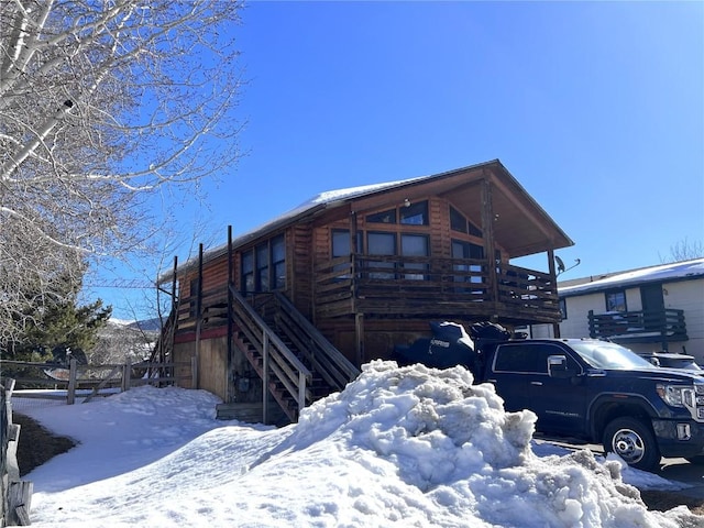 view of snow covered exterior featuring stairway