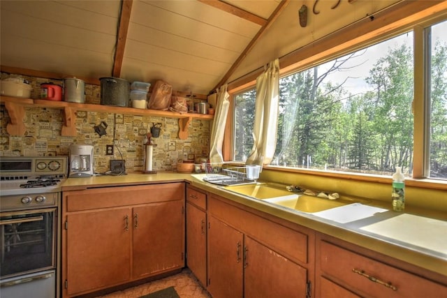 kitchen featuring open shelves, light countertops, vaulted ceiling with beams, wooden ceiling, and gas stove