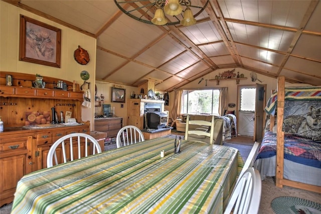 dining room featuring vaulted ceiling, wood walls, and carpet