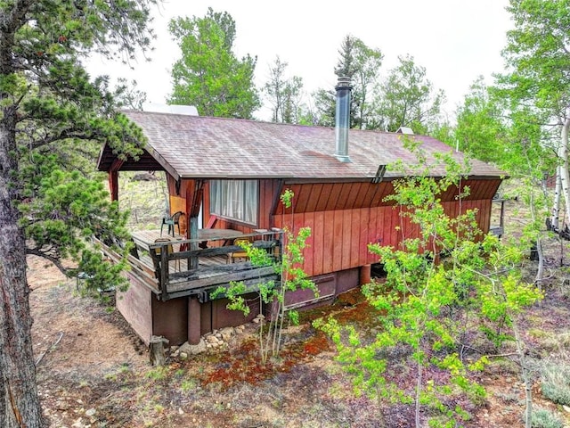 back of property with a shingled roof