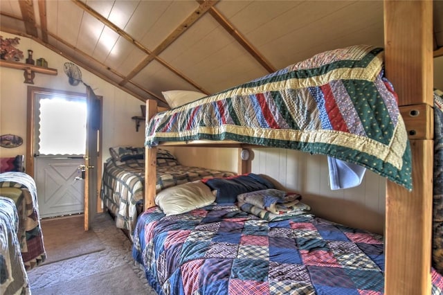 bedroom with carpet flooring and vaulted ceiling with beams