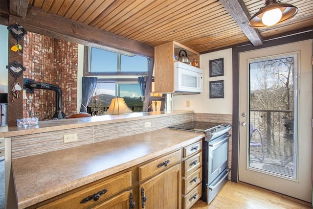 7237 Ryan Gulch Rd Unit 307, Silverthorne, CO 80498 - kitchen with stainless steel range with electric stovetop, wood ceiling, white microwave, beam ceiling, and light wood-type flooring