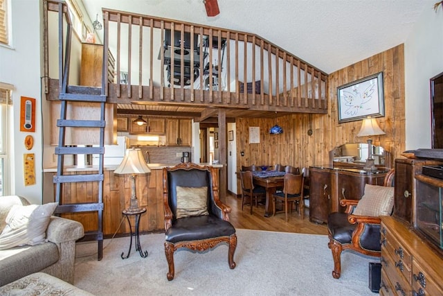 7237 Ryan Gulch Rd Unit 307, Silverthorne, CO 80498 - living room featuring wooden walls, carpet floors, and a textured ceiling