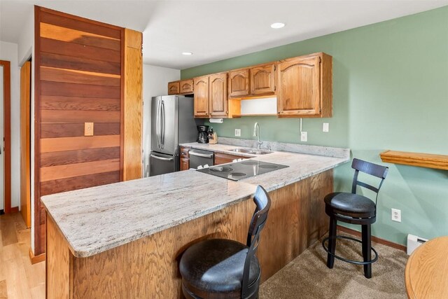 9430 Ryan Gulch Rd Unit 9453, Silverthorne, CO 80498 - kitchen featuring a sink, stainless steel appliances, a kitchen breakfast bar, a peninsula, and baseboard heating