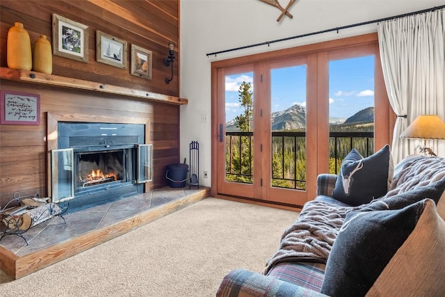 9430 Ryan Gulch Rd Unit 9453, Silverthorne, CO 80498 - carpeted living area featuring a mountain view, a glass covered fireplace, and wooden walls