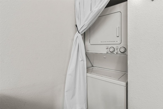 9430 Ryan Gulch Rd Unit 9453, Silverthorne, CO 80498 - laundry room featuring stacked washing machine and dryer and a textured wall