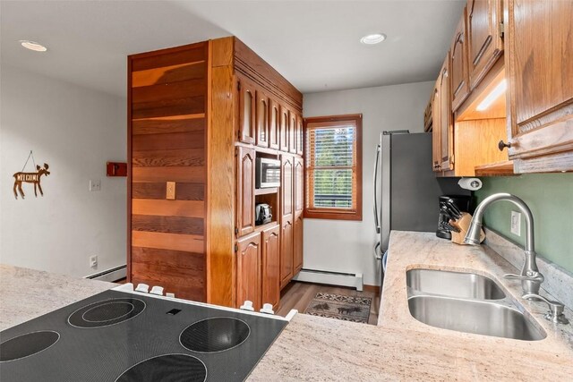 9430 Ryan Gulch Rd Unit 9453, Silverthorne, CO 80498 - kitchen with a sink, baseboard heating, electric stove, brown cabinets, and recessed lighting