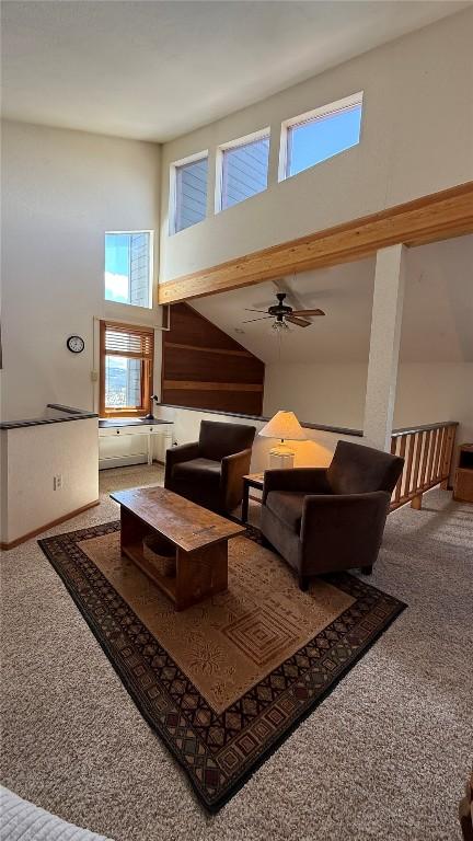 9430 Ryan Gulch Rd Unit 9453, Silverthorne, CO 80498 - living area with carpet floors, a high ceiling, and a ceiling fan