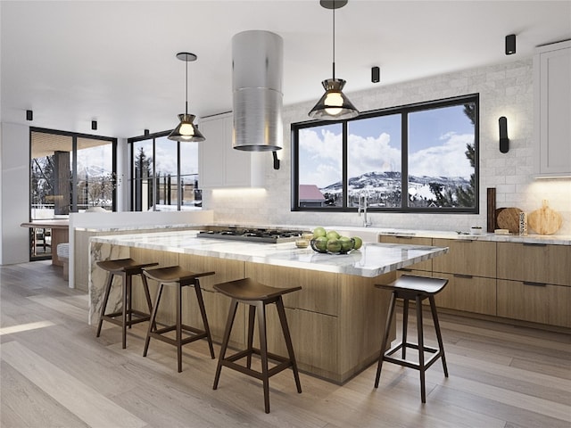 TBD Deerfoot Ave, Steamboat Springs, CO 80487 - kitchen with backsplash, stainless steel gas stovetop, light wood-style floors, and a breakfast bar area