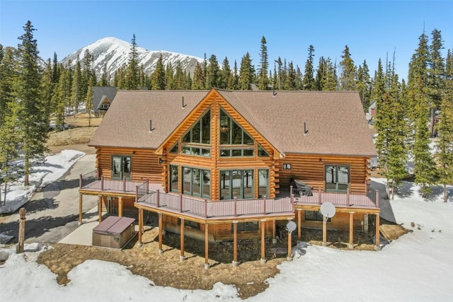 306 Robertson Ln, Breckenridge, CO 80424 - snow covered house with log siding and a deck with mountain view