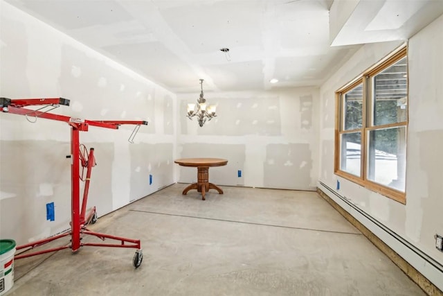 306 Robertson Ln, Breckenridge, CO 80424 - spare room featuring a baseboard radiator, concrete floors, and a chandelier