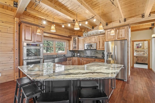 306 Robertson Ln, Breckenridge, CO 80424 - kitchen with appliances with stainless steel finishes, wood ceiling with exposed beams, a sink, dark wood-style floors, and light stone countertops
