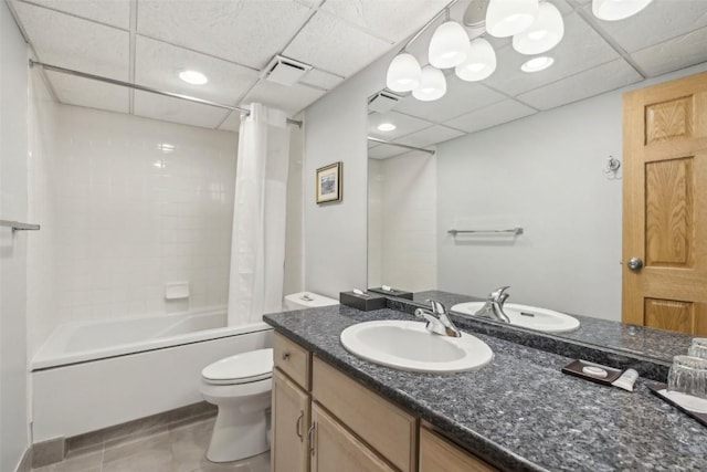 bathroom featuring a paneled ceiling, visible vents, toilet, and shower / tub combo with curtain
