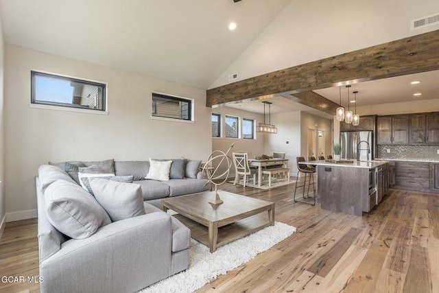 living area featuring visible vents, recessed lighting, wood finished floors, and a chandelier