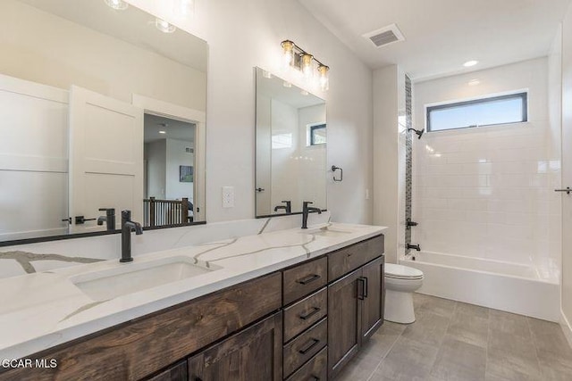 full bath featuring a sink, toilet, double vanity, and visible vents