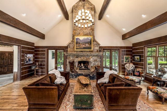 215 Royal Tiger Rd, Breckenridge, CO 80424 - living room with beam ceiling, high vaulted ceiling, a stone fireplace, and wood finished floors