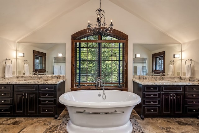 215 Royal Tiger Rd, Breckenridge, CO 80424 - bathroom with a freestanding tub, a chandelier, two vanities, and high vaulted ceiling