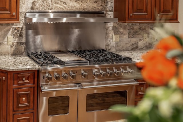 215 Royal Tiger Rd, Breckenridge, CO 80424 - kitchen with decorative backsplash, double oven range, and light stone counters