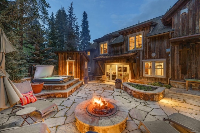 215 Royal Tiger Rd, Breckenridge, CO 80424 - rear view of property with a fire pit, a patio area, board and batten siding, and french doors