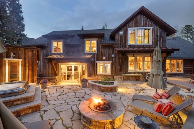 215 Royal Tiger Rd, Breckenridge, CO 80424 - rear view of house with an outdoor fire pit, a patio area, roof with shingles, and french doors
