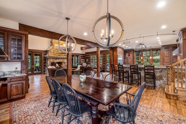 215 Royal Tiger Rd, Breckenridge, CO 80424 - dining space with a chandelier, light wood-style floors, recessed lighting, beam ceiling, and french doors