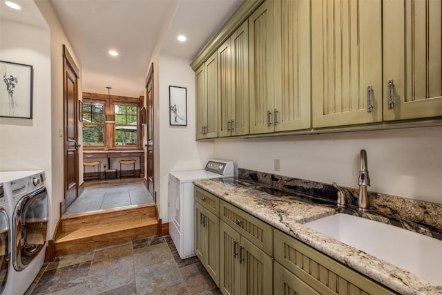 215 Royal Tiger Rd, Breckenridge, CO 80424 - washroom with washing machine and clothes dryer, cabinet space, stone tile floors, and recessed lighting