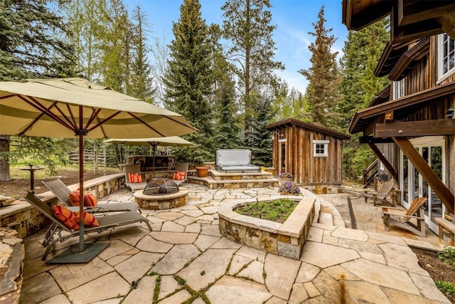 215 Royal Tiger Rd, Breckenridge, CO 80424 - view of patio featuring a fire pit, a storage shed, and area for grilling