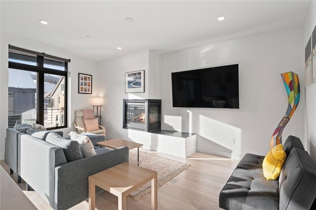 living room featuring light wood-type flooring and recessed lighting