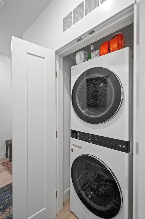 laundry area featuring stacked washer / drying machine and laundry area