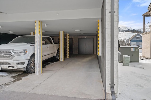 garage with a carport and a mountain view