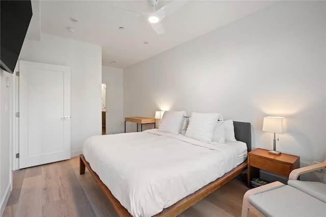 bedroom featuring wood finished floors, baseboards, and ceiling fan