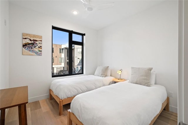 bedroom with light wood-style floors, access to outside, and baseboards