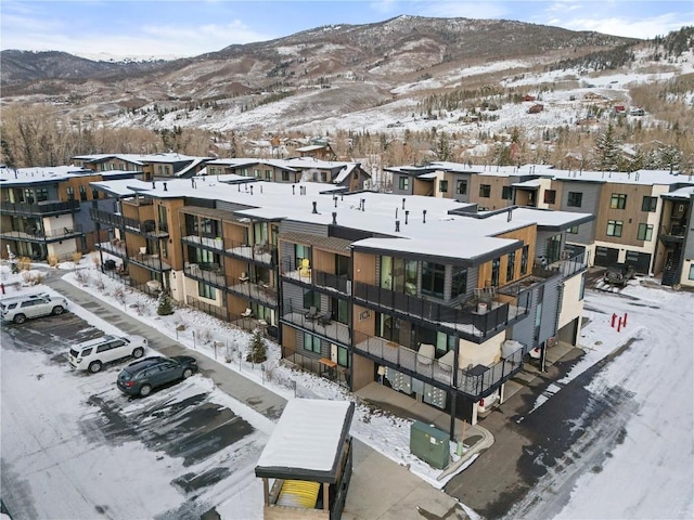 snowy aerial view featuring a mountain view