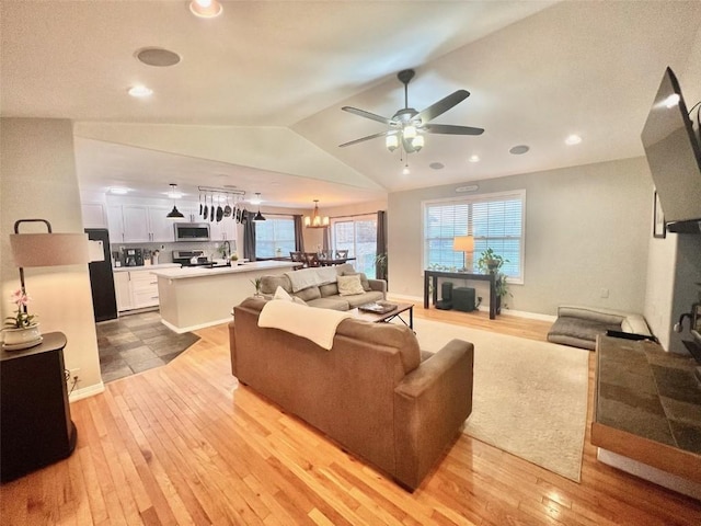158 Oak Ridge Cir, Oak Creek, CO 80467 - living area featuring light wood-style floors, a ceiling fan, vaulted ceiling, a chandelier, and recessed lighting