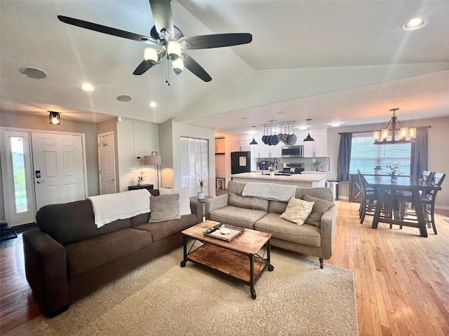 158 Oak Ridge Cir, Oak Creek, CO 80467 - living area with vaulted ceiling, light wood-type flooring, a chandelier, a ceiling fan, and recessed lighting