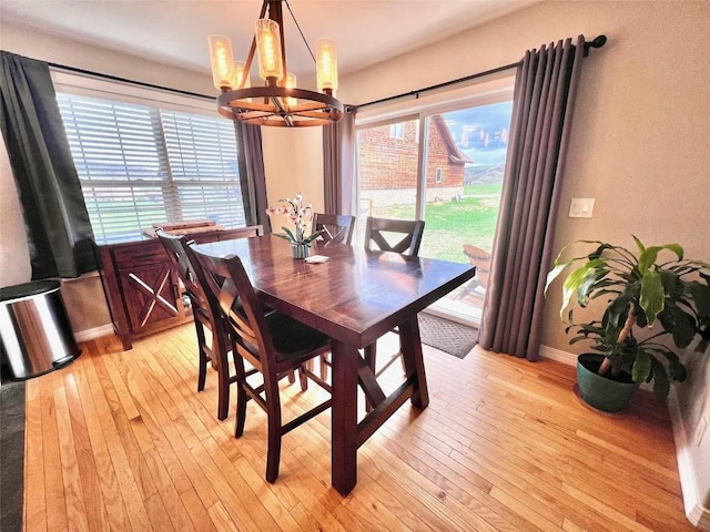 158 Oak Ridge Cir, Oak Creek, CO 80467 - dining room with a chandelier, baseboards, and light wood-style flooring