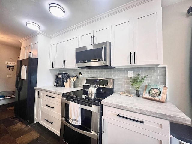 158 Oak Ridge Cir, Oak Creek, CO 80467 - kitchen with stainless steel appliances, light countertops, tasteful backsplash, and white cabinetry