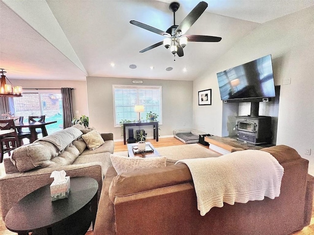 158 Oak Ridge Cir, Oak Creek, CO 80467 - living area with vaulted ceiling, a wood stove, a ceiling fan, light wood-style flooring, and baseboards